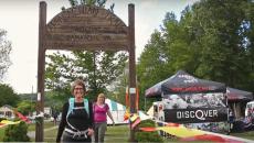 Hikers walking below an Appalachian trail sign