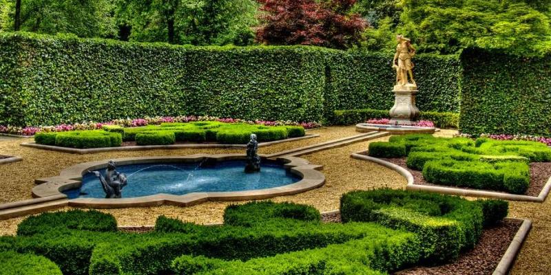 Manicured garden with fountain, statue, and paths