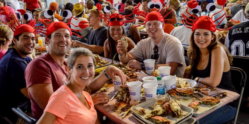 Diners wear crab hats at the Annapolis Crab Feast in Annapolis, Maryland, USA.