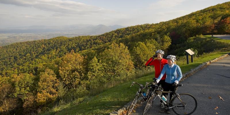 Bikers along the Blue Ridge Parkway stopping on the edge of the road to look at the rolling Blue Ridge Mountains in Virginia, USA