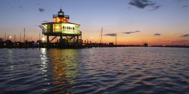 The squat, hexagonal Choptank River Lighthouse at sunset in Cambridge, Maryland, USA