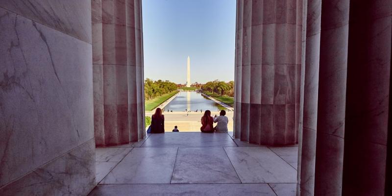 A photograph from the inside of the Lincoln Memorial looking out at the Washington Monument in Washington, DC, USA.