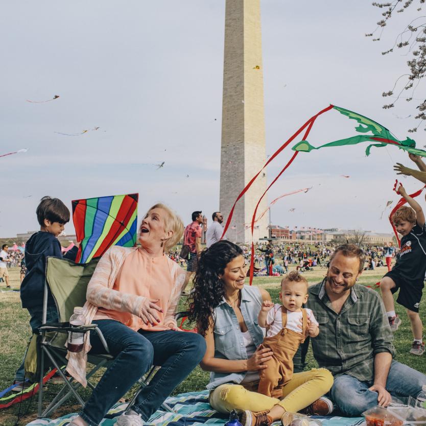 A family picnics during the Kite Festival in front of the Washington Monument in Washington, DC.